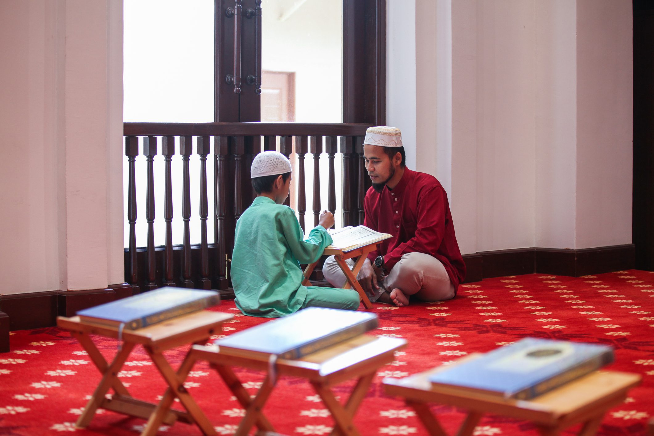 Father and son reading Quran