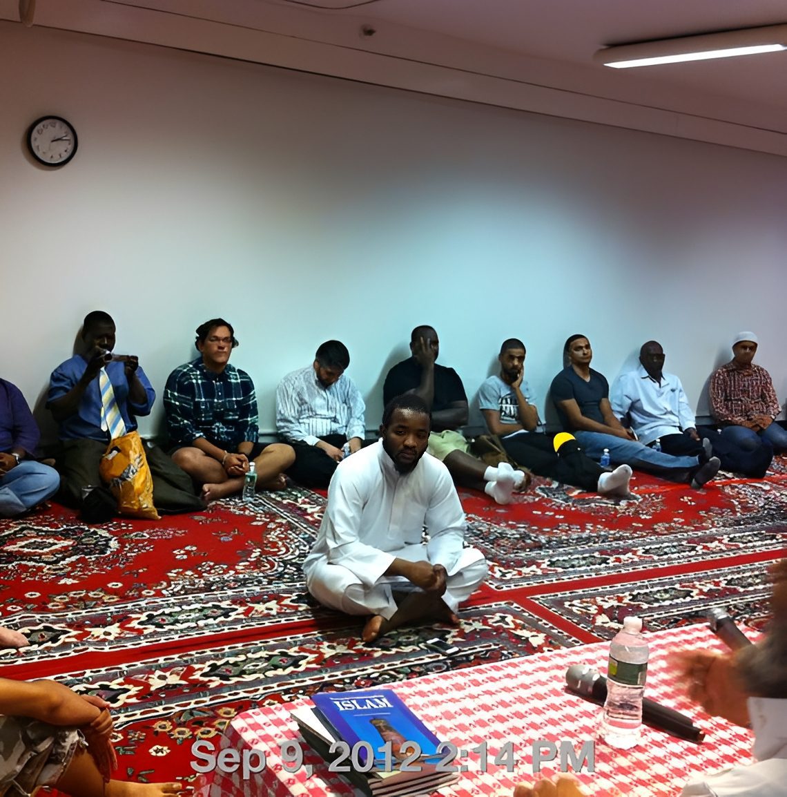 Men gathered on patterned rug