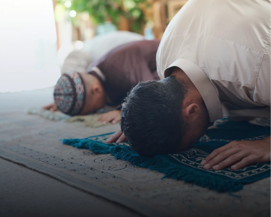 Devout individuals bowing in religious observance