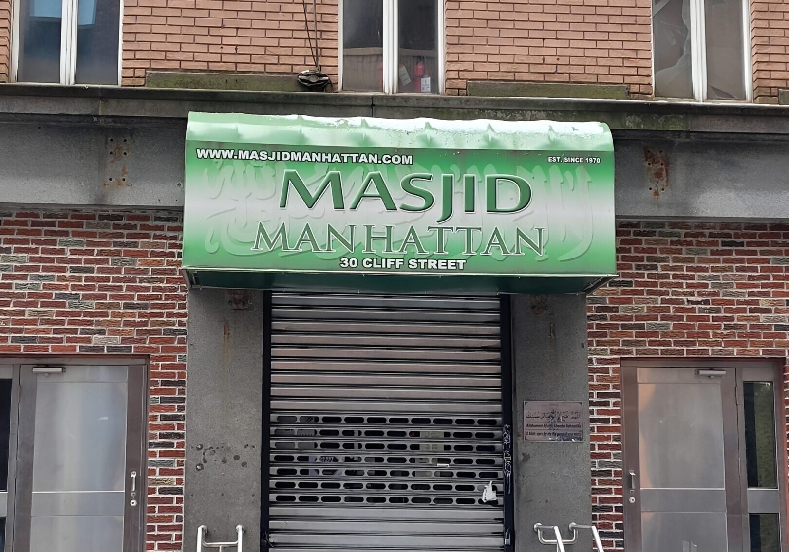Brick building with mosque sign